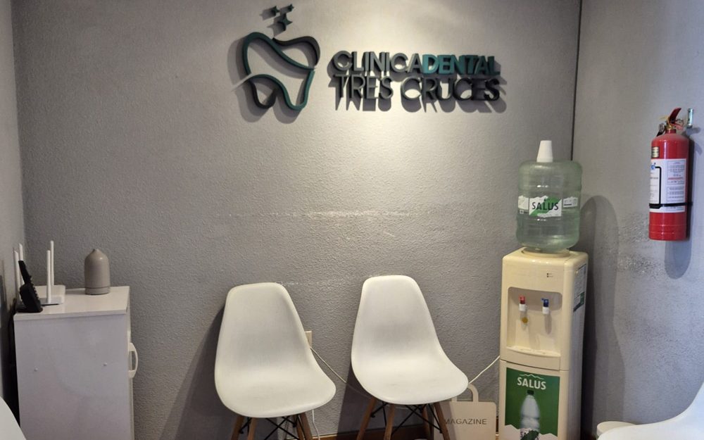 Sala de espera de la clínica con el logo en la pared